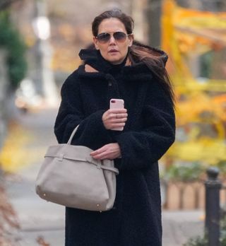 Katie Holmes carrying a suede Manu Atelier bag.