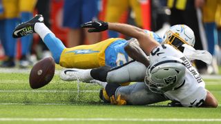 Wide receiver Hunter Renfrow #13 of the Las Vegas Raiders reacts after fumbling the ball while being tackled by safety Nasir Adderley #24 of the Los Angeles Chargers during the third quarter at SoFi Stadium on September 11, 2022 in Inglewood, California.