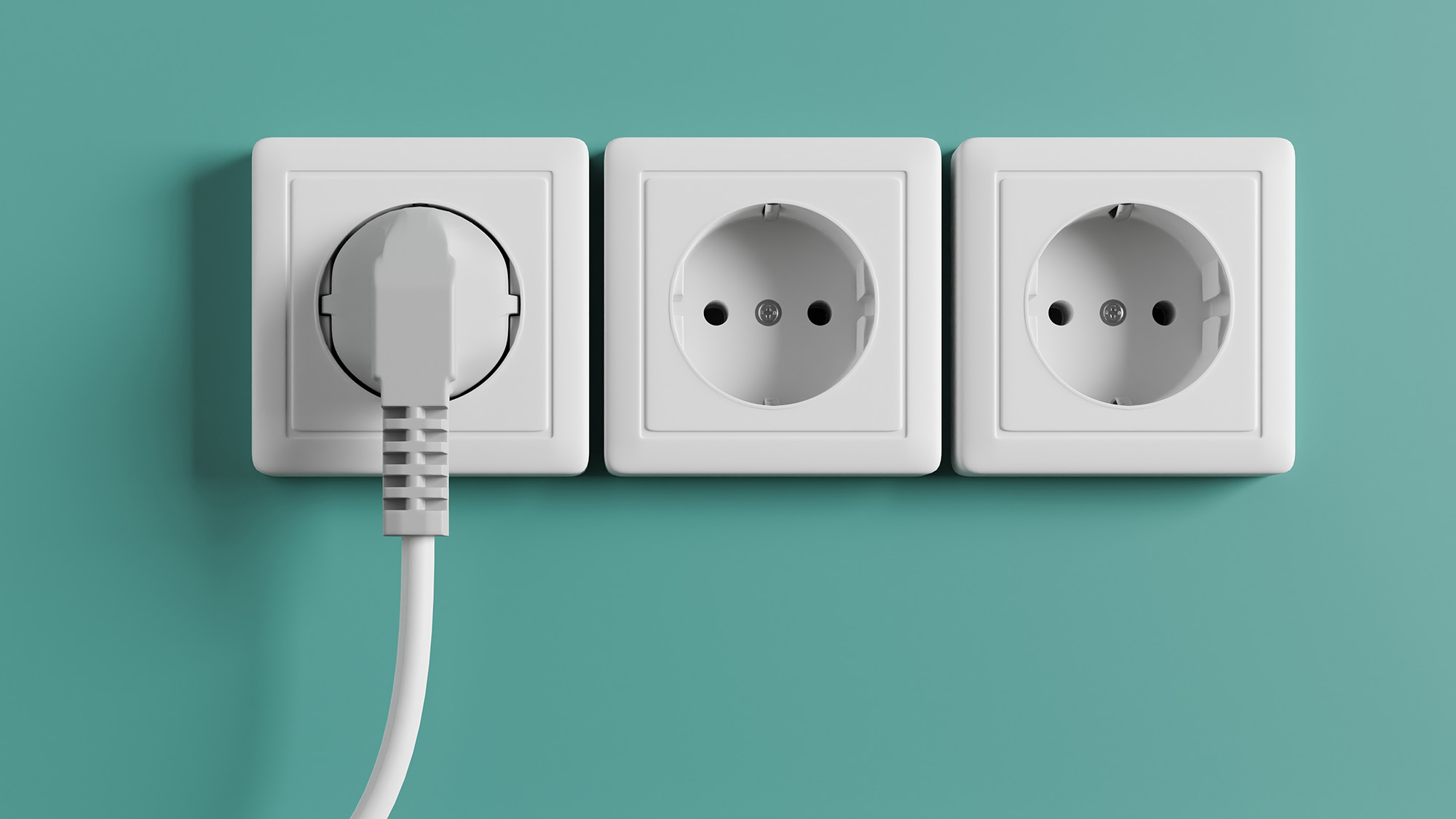 A white electrical outlet on the wall in the room.