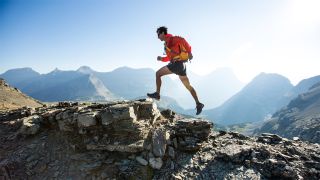 Man running alone on mountain ridge