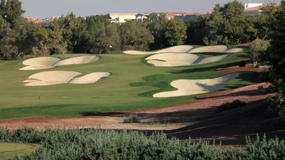The par-4 5th hole on the Earth Course at Jumeirah Golf Estates showing what is a bunker in golf