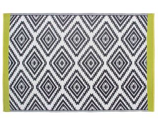 A geometric patterned black and white outdoor rug with lime green edges