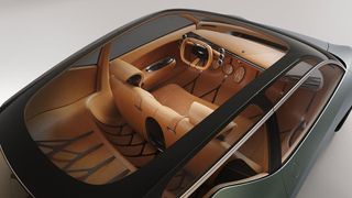 Genesis Mint photographed from above. Through the glass roof, we see the all leather interior in light orange-brown color.