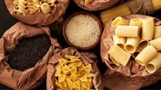 Bowls and bags of white pasta and rice, representing resistant starch as a GLP-1 alternative