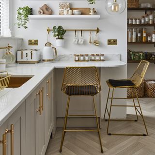 White kitchen with matching white walls and shaker cabinets.