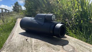 Python Rangemaster monocular on a wooden bench outside