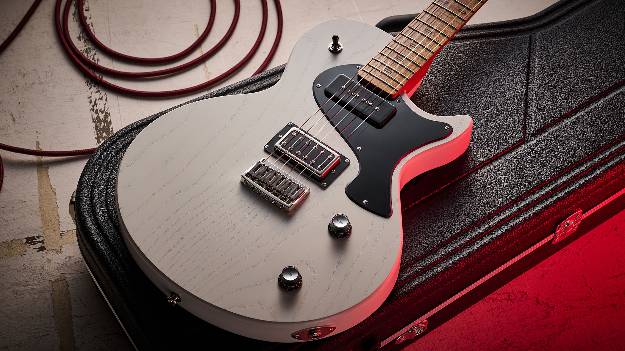 PJD Carey Classic: the translucent white singlecut has a handsome roasted figured maple neck, a black pickguard, and a P-90/Humbucker pairing.