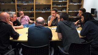 Games Workshop team crowded around a meeting table
