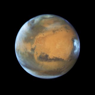 A global view of Mars, captured by the Hubble Space Telescope. The wide view lets scientists observe how climate impacts the entire planet. 