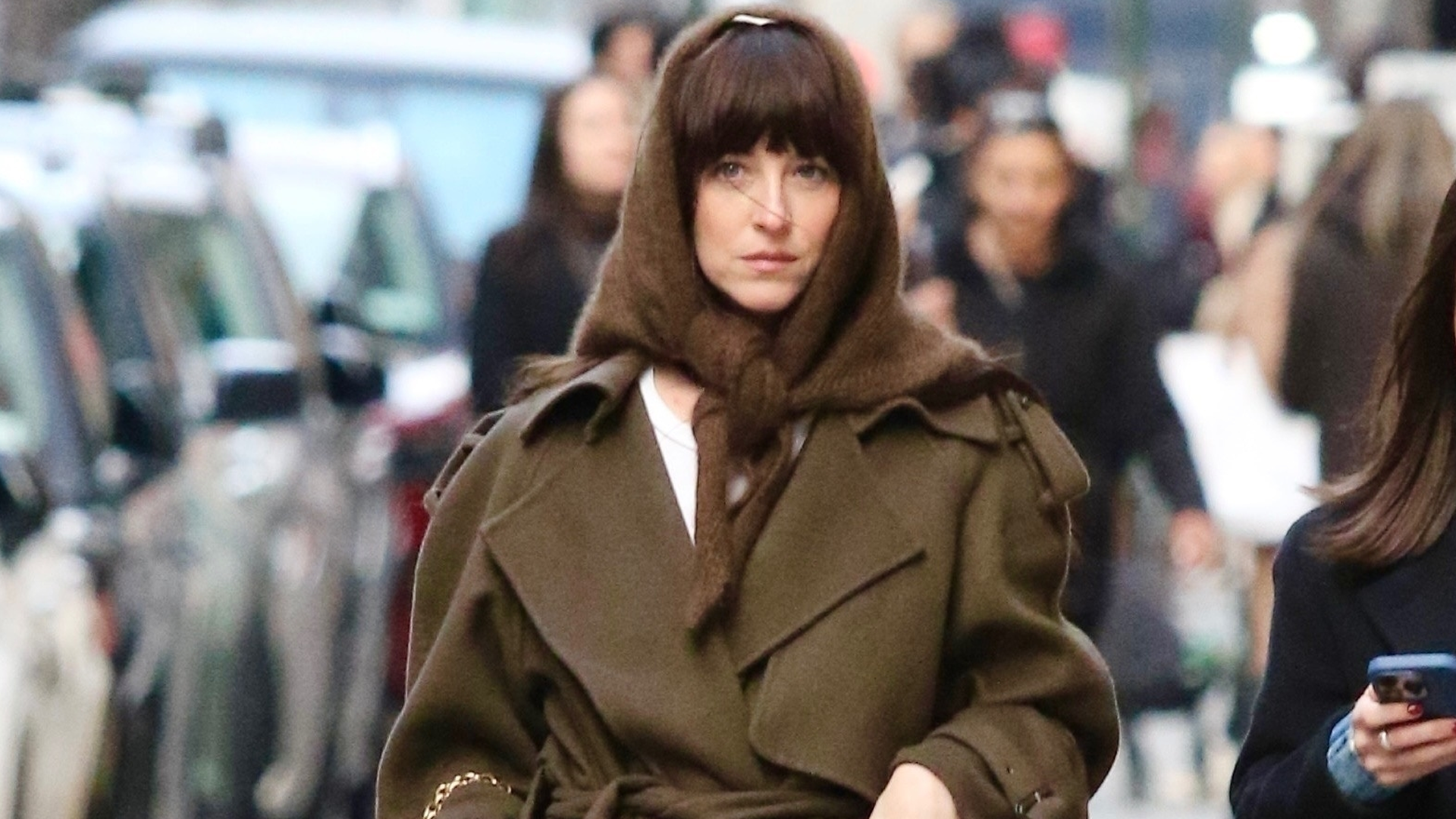 Dakota Johnson tested the triangle scarf trend with her wool The Row wrap coat and ballet flats