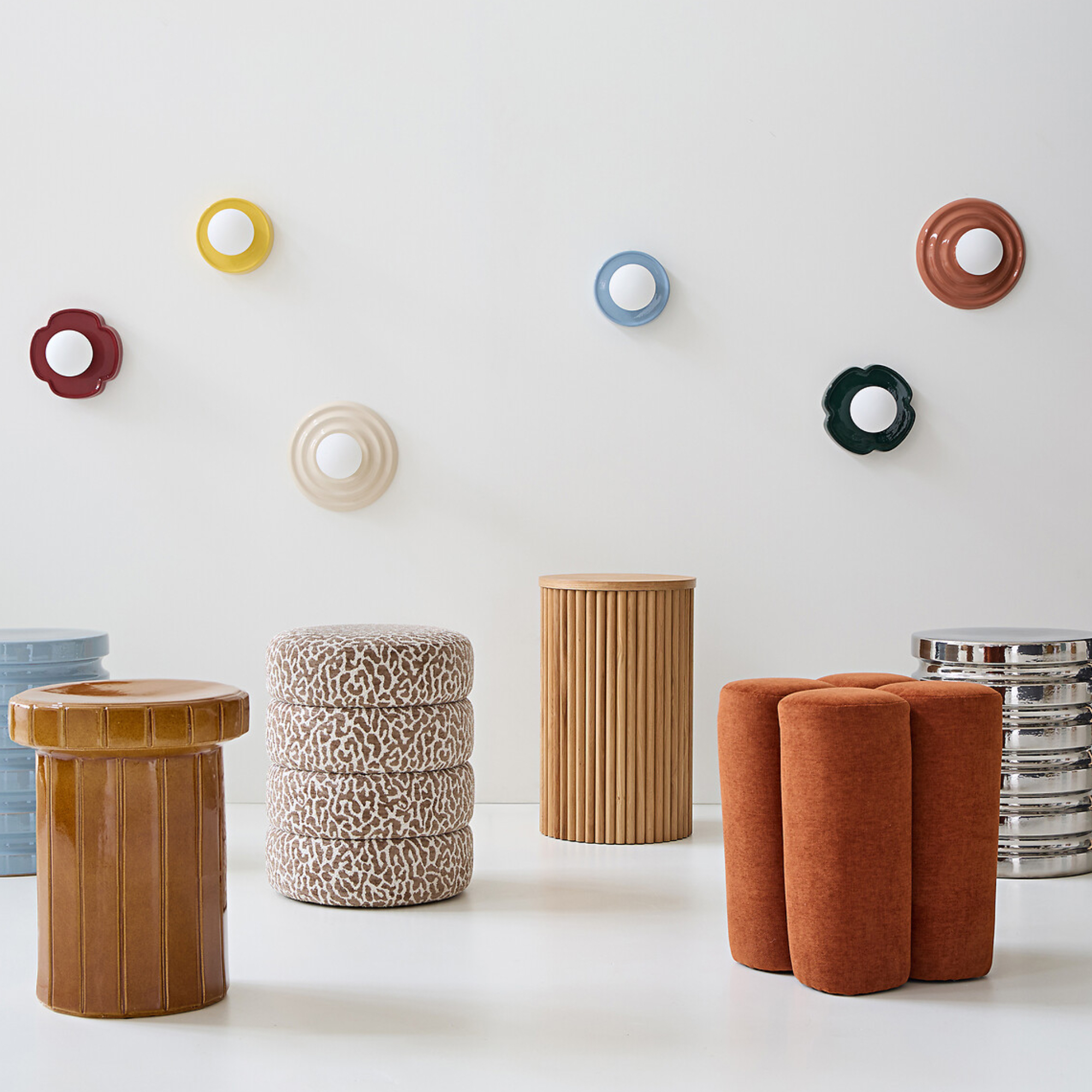 different side tables with colourful wall lights above
