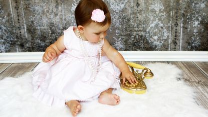 Millionaire baby names illustrated by baby n pink dress with gold phone