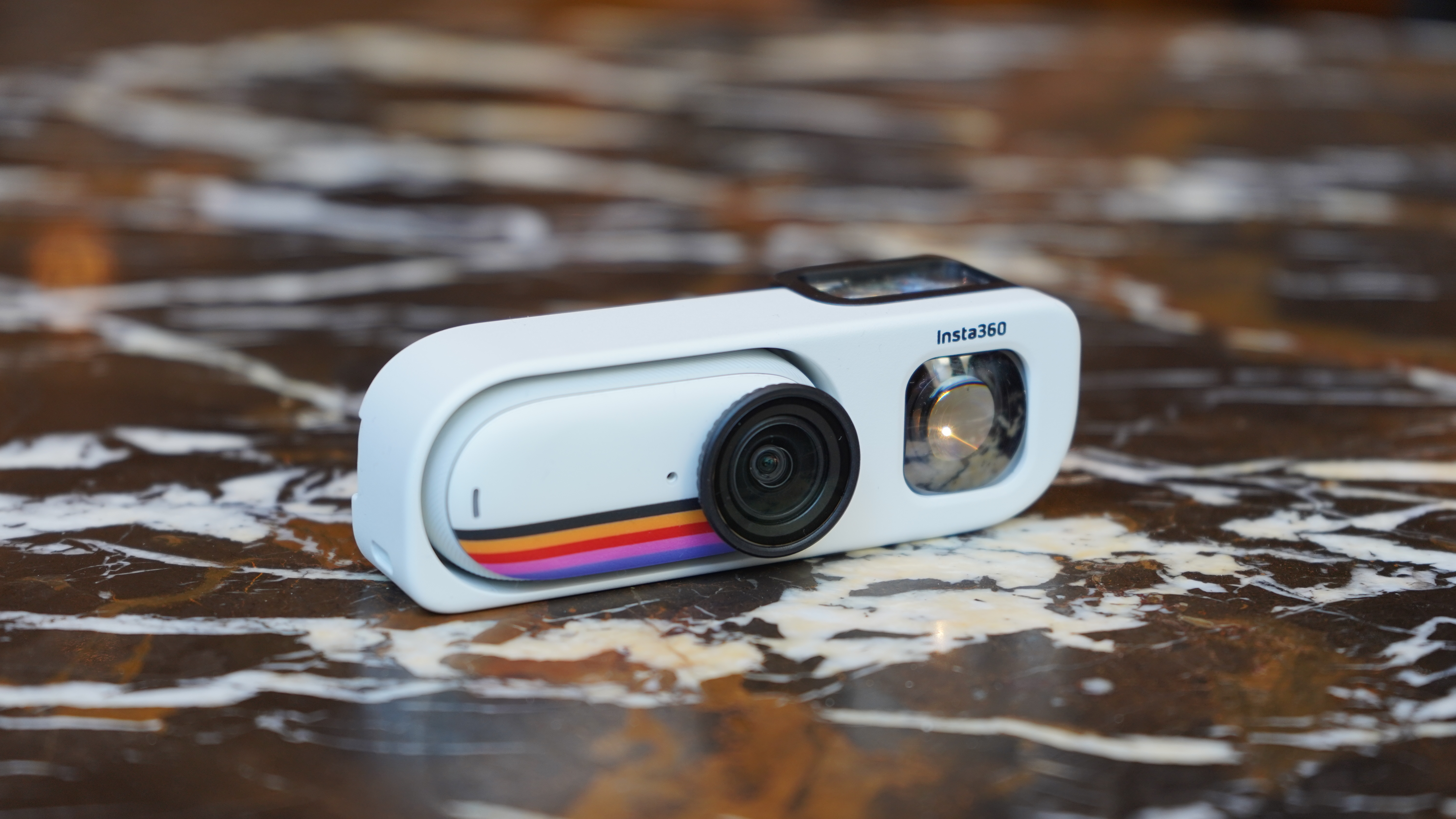 Insta360 GO 3S Retro camera in housing on table