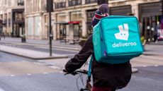 A Deliveroo worker cycles through London