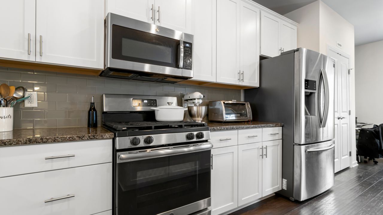 If you’re thinking where to put a microwave in a small kitchen like this silver and white one we have you covered