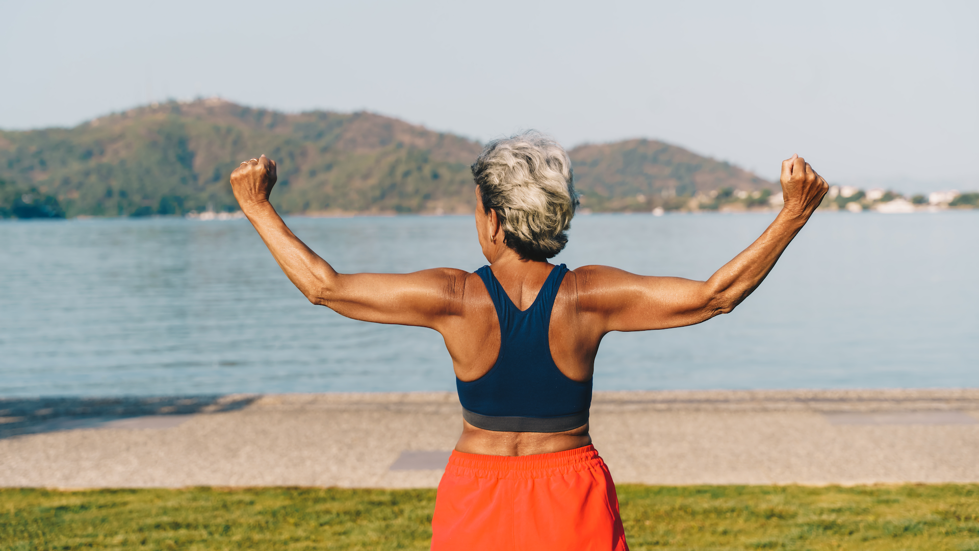 Woman flexing her muscles while exercising outdoors