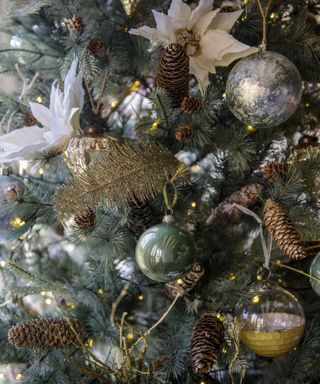Christmas tree branches with ornaments and pine cone decorations