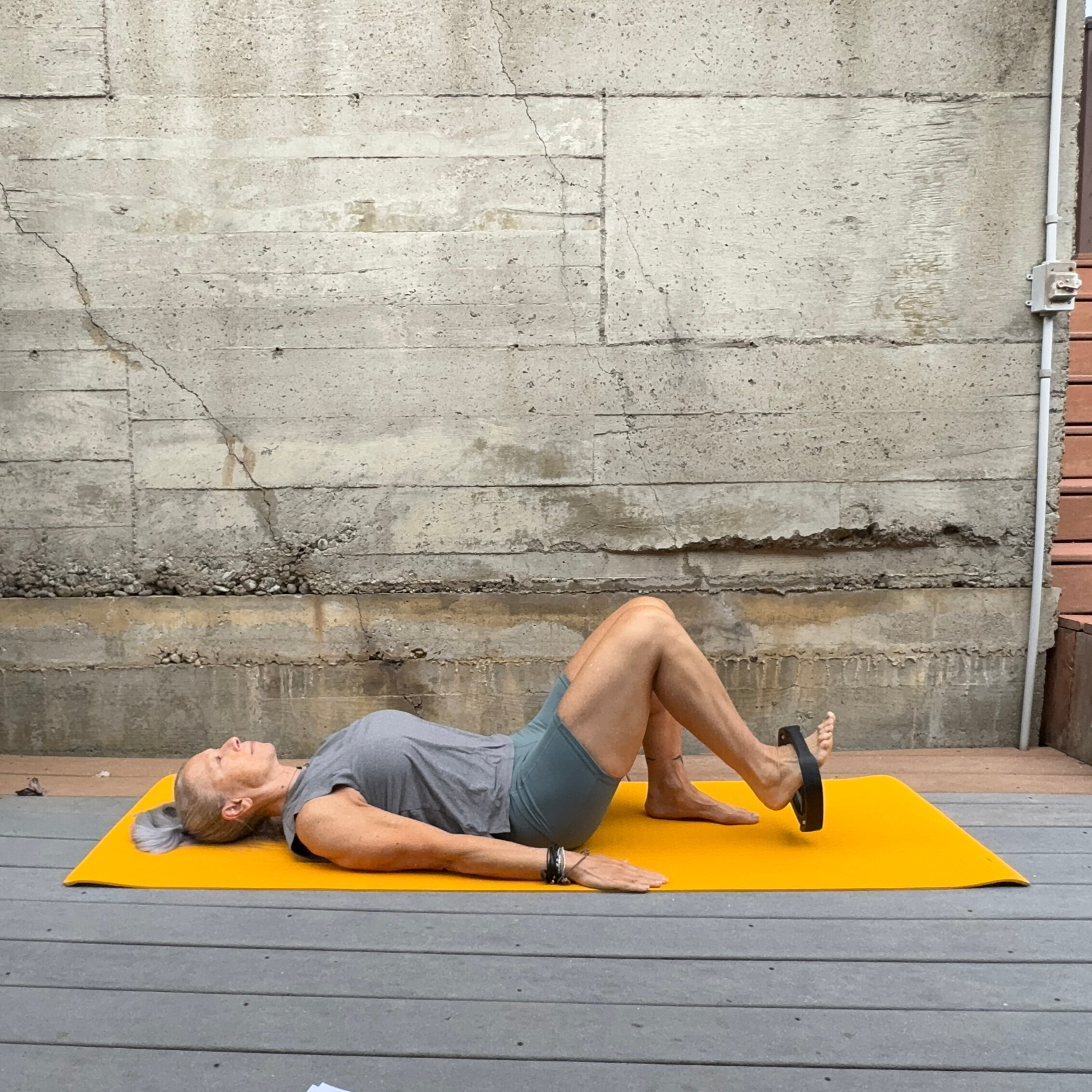 Woman exercising with weight plate
