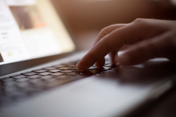 A person typing on a keyboard. 