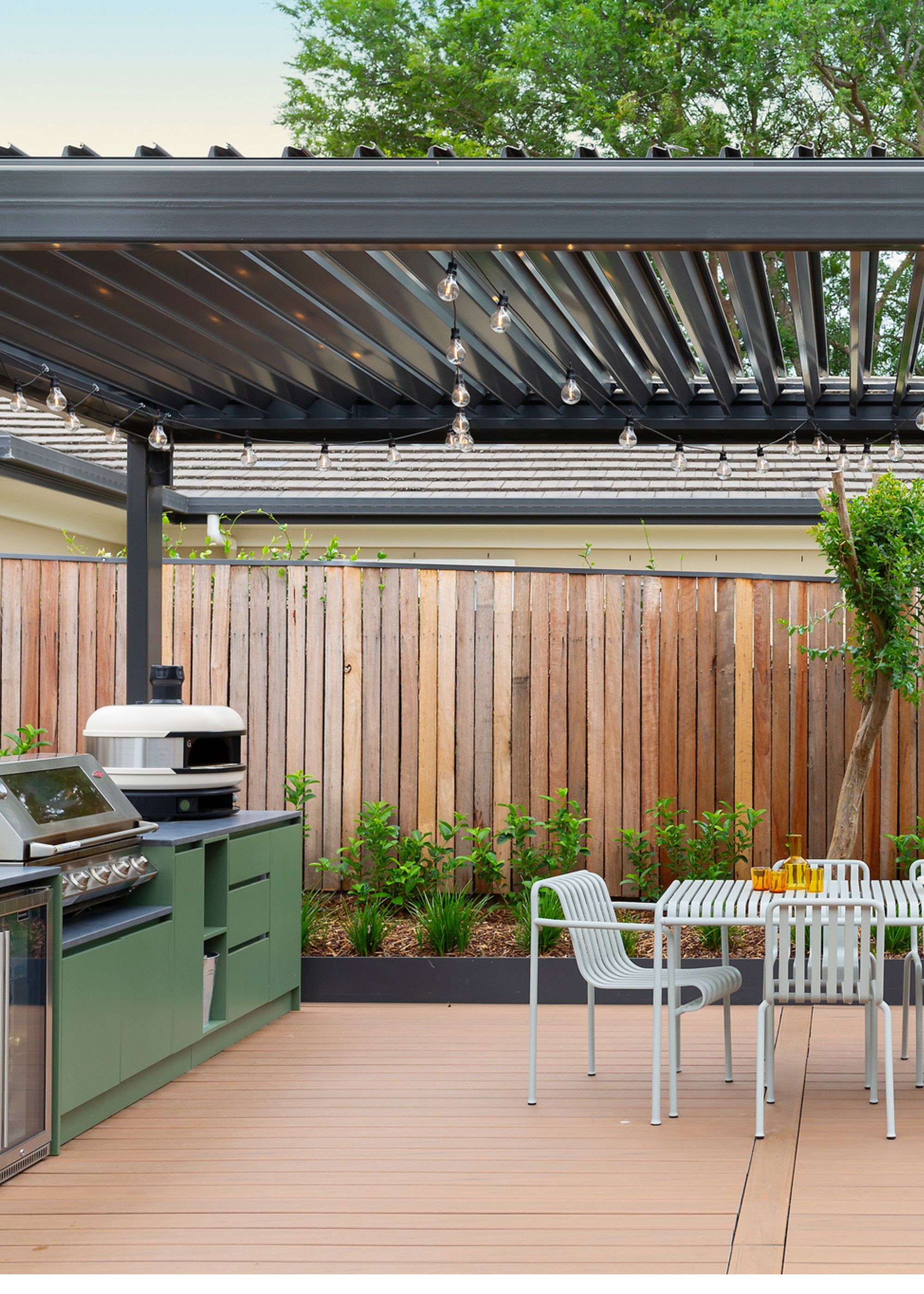 a large pergola above an outdoor kitchen and dining area