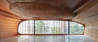 Interior view of Vikasa yoga studio, Bangkok with curved 3D tubular feature suspended from the ceiling