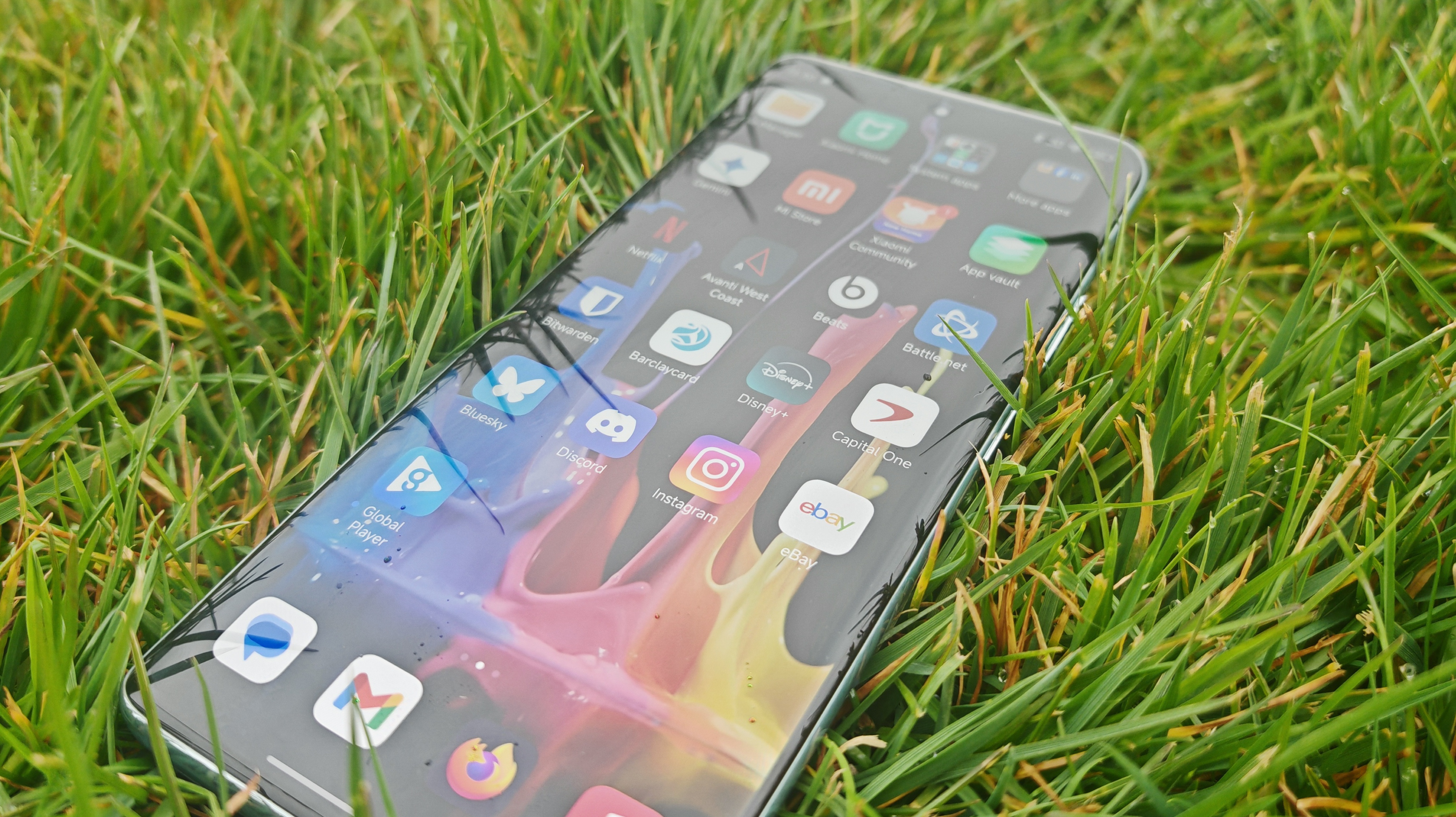Xiaomi Redmi Note 14 Pro Plus 5G phone in hand and on grass showing homescreens and cameras up close