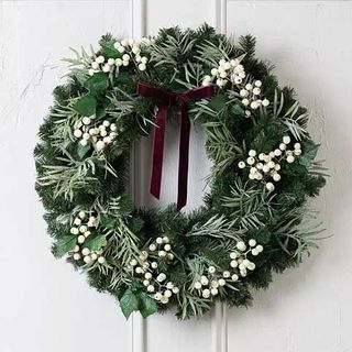 a wreath with snow berries