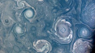 Colorful storms around the north pole of Jupiter captured by the Juno probe during its close approach to the planet in July 2022.