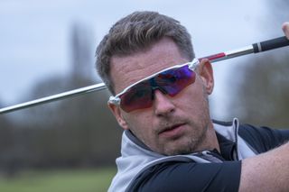 man wearing Oakley Radar EV Path sunglasses during golf swing