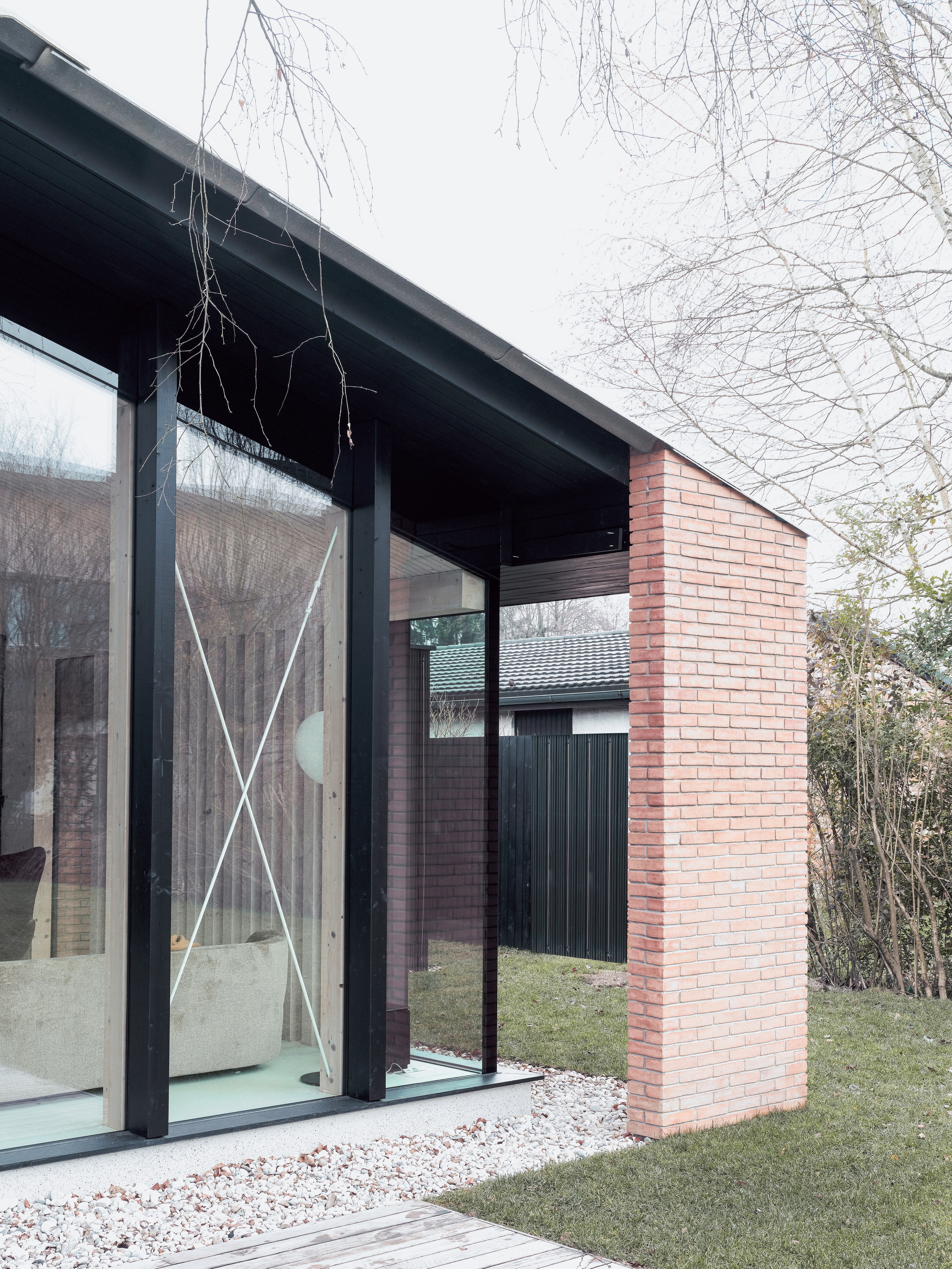 The brick piers recall the location of the original house