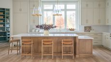 neutral kitchen with timber island and green pantry