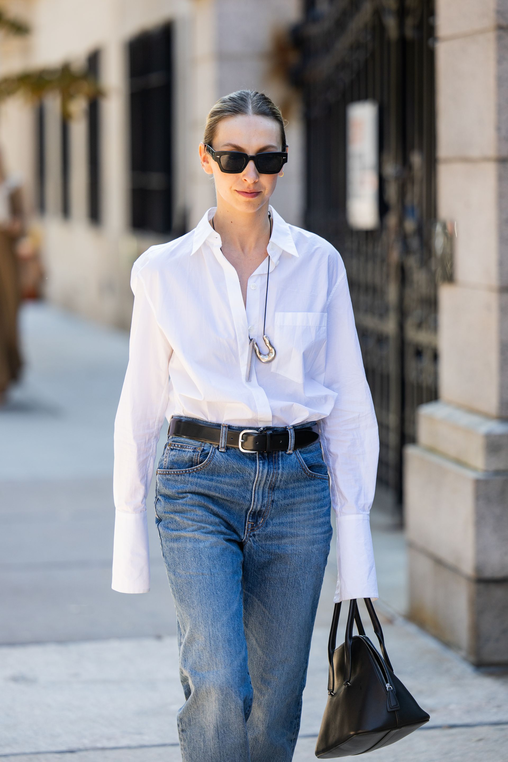 Woman in a white shirt and jeans.