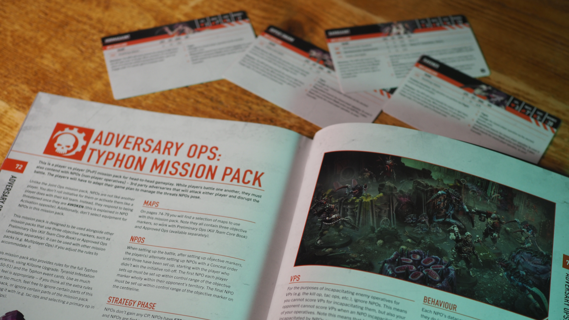 Typhon book open on a wooden table displaying the Adversary Ops page, with cards for NPOs nearby