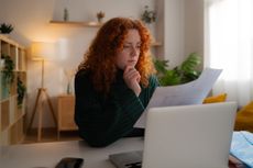 Inheritance tax penalties concept: woman reading a form