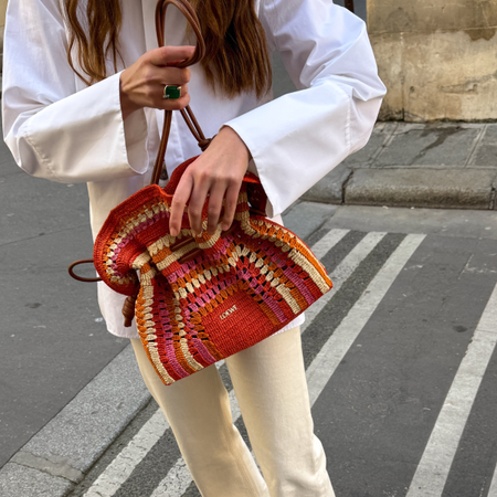 An image of a woman wearing colorful straw bag for summer 2026