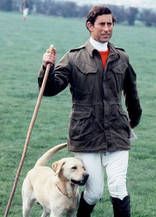 King Charles walking with a pet Labrador