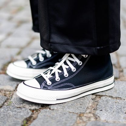 Influencer Maria Barteczko wearing black sneakers by Converse during a street style shooting on July 15, 2022 in Berlin, Germany