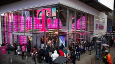 Customers line up outside a T-Mobile store