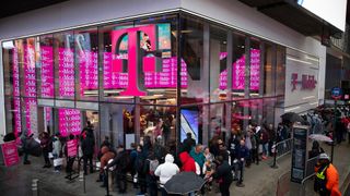 Customers line up outside a T-Mobile store
