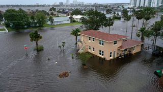 In this aerial view, flood water surround a building after Hurricane Nicole came ashore on November10, 2022 in Daytona Beach, Florida. Nicole came ashore as a Category 1 hurricane before hitting Florida's east coast.