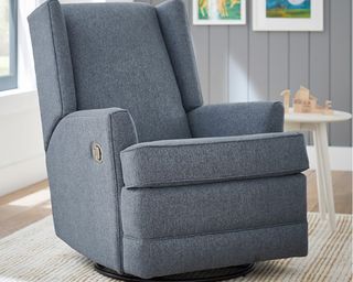 Image of Pottery Barn Kids Modern Wingback Reclining Nursing Chair in a modern grey and white nursery with a wooden floor