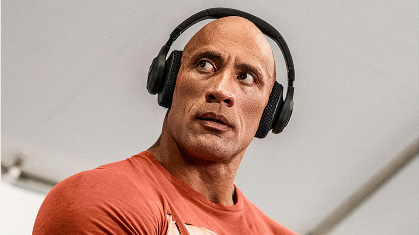 The Rock Dwayne Johnson wearing the Project Rock Over-Ear Headphones.
