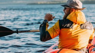 Man wearing Polar Grit X Pro while kayaking
