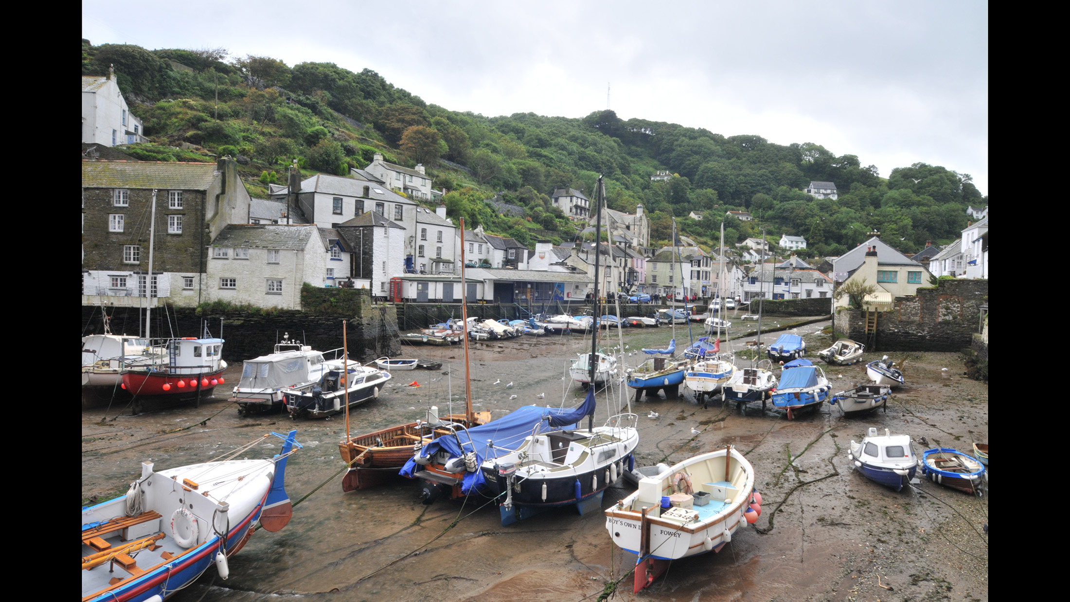 Harbour, no water, fishing boats, cloudy sky