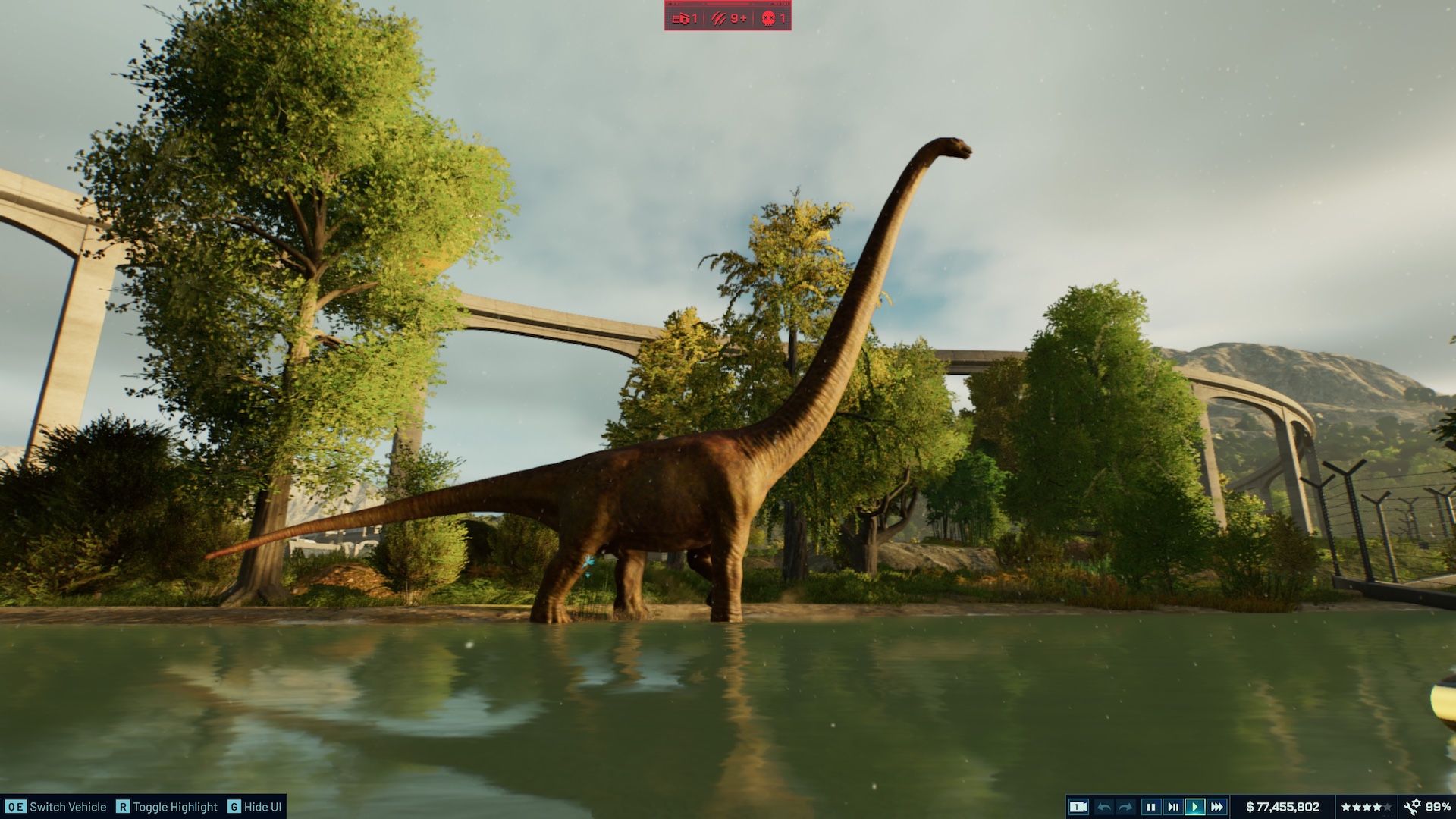 A Mamenchisaurus lit by the sun standing by some water in Jurassic World Evolution 3.