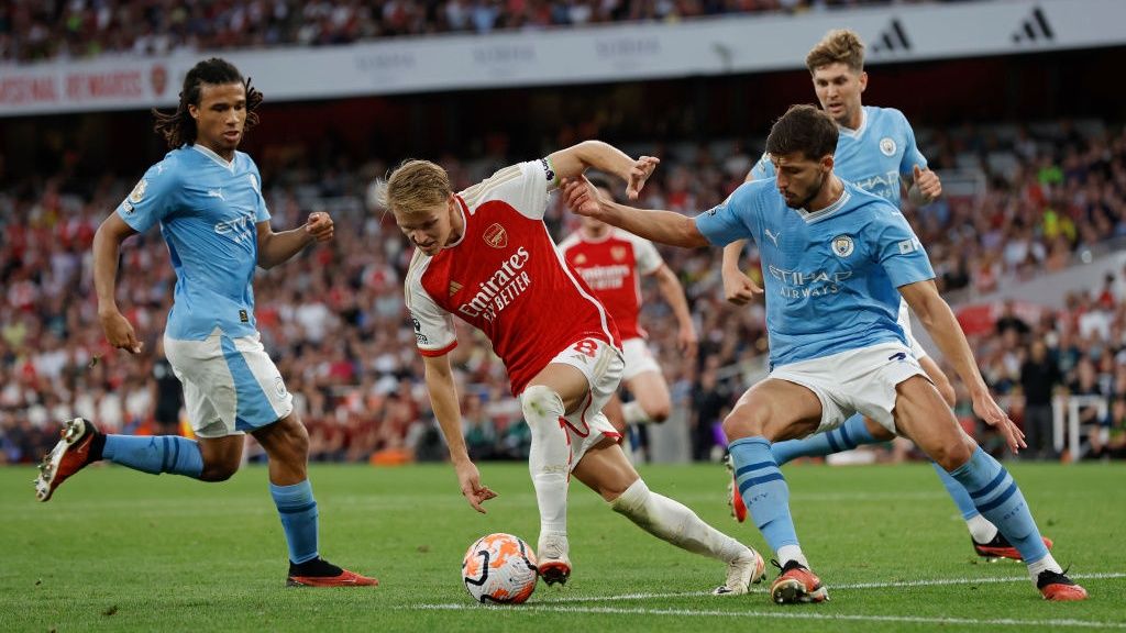 Martin Odegaard of Arsenal dribbles between City defenders during the F.A. Premier League match between Arsenal and Manchester City at the Emirates Stadium on October 8th 2023 in London, England