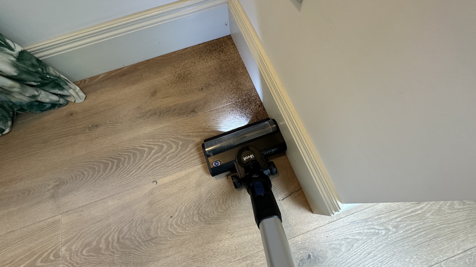 Levoit LVAC-300 vacuum cleaning up to the edge of a room