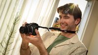 Photographer using the Canon EOS R100 indoors