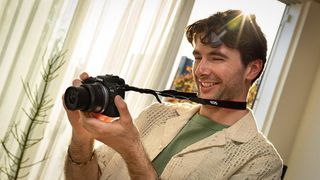 Photographer using the Canon EOS R100 indoors