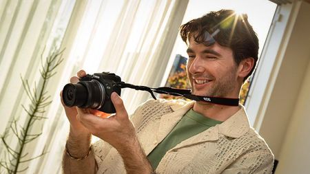 Photographer using the Canon EOS R100 indoors